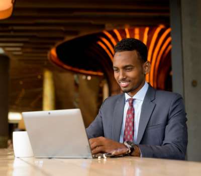 Portrait of African businessman wearing suit and tie in coffee shop