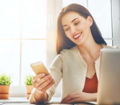 Woman is using phone.